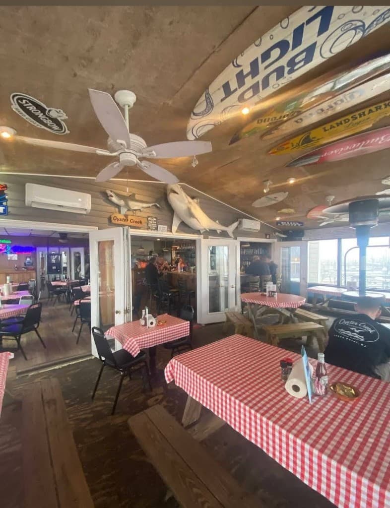 Open dining room with wood tables leading into the bar