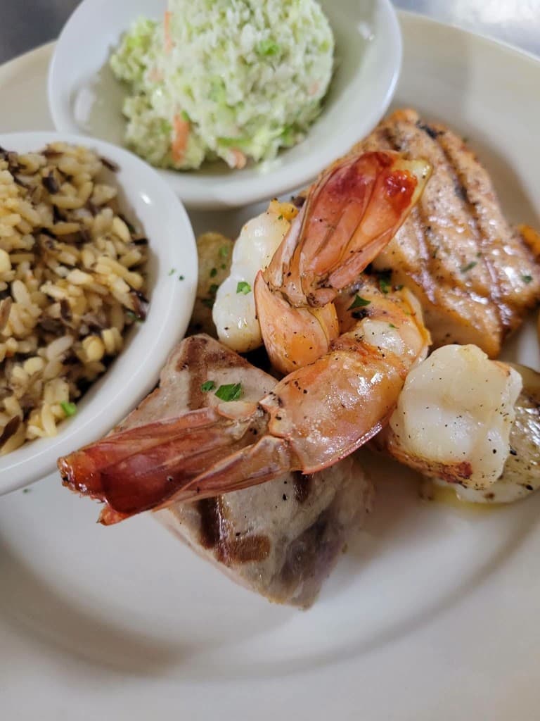 Grilled shrimp and fish plate with rice and coleslaw